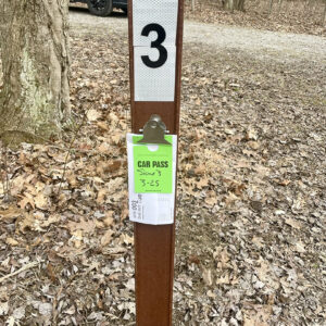 sign post with papers cliped to it