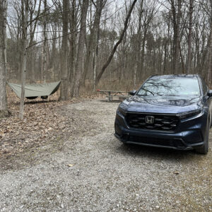 Rain tarp and parked car at a campsite